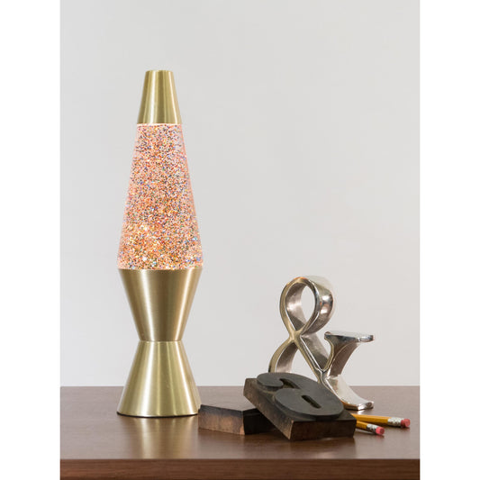 14.5” LAVA® Lamp Rainbow Glitter – Clear/Gold on a table with knick knacks