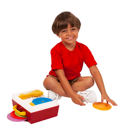 Lifestyle shot of boy playing with the Fisher-Price Music Box Record Player