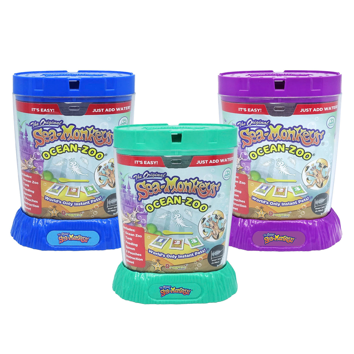 Three Ocean Zoo aquariums sit side by side. One with a blue lid and base is on the left, one with a teal lid and base is in the middle, and one with a purple lid and base is on the right. All three have packaging inserts in the clear part of the aquarium which states the product name and information.