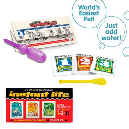 Three packets, numbered 1, 2, and 3 from left to right. There is a small yellow Sea-Monkeys spoon laying in front of the packets. There is a purple pipette and folded instruction paper laying behind the packets, and a peice of the box highlighted in front of the packets. There are two callouts in circles. One reads "World's Easiest Pet!" and the other reads "Just add water!" Three packets, numbered 1, 2, and 3 from left to right. There is a small yellow Sea-Monkeys spoon laying in front of the p