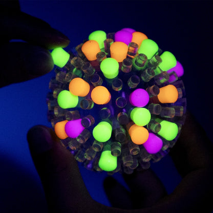 Brite Ball glow in the dark caps being placed on Brite Ball in the dark