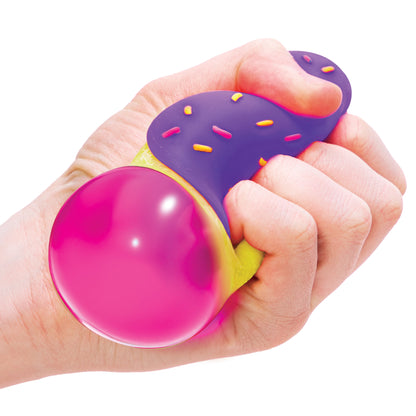 NeeDoh Jelly Donuts - Yellow Dohnut with Purple Frosting Being Squeezed in Hand