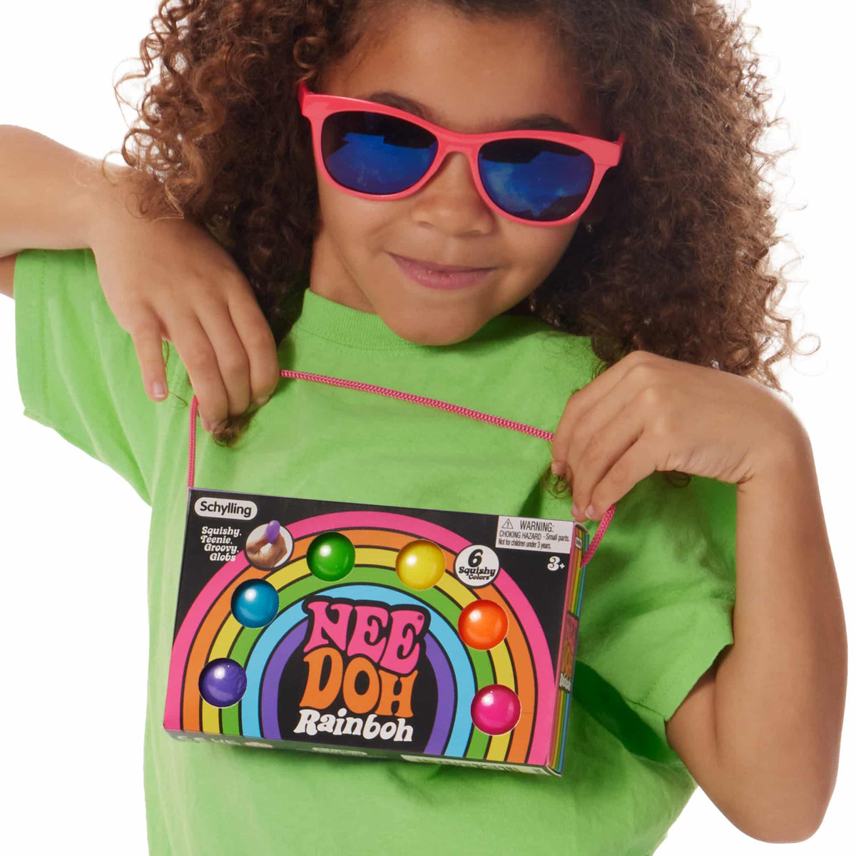 Girl holding the NeeDoh Rainboh packaging
